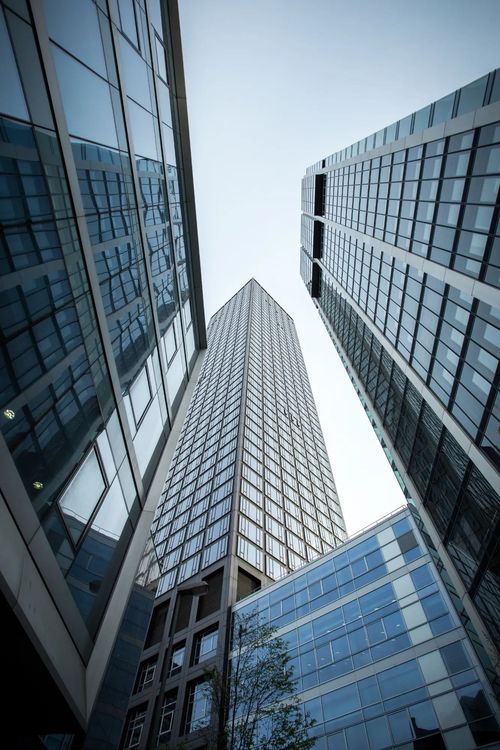 vertical-low-angle-shot-high-rise-skyscrapers-glass-facade-frankfurt-germany-1 (1)